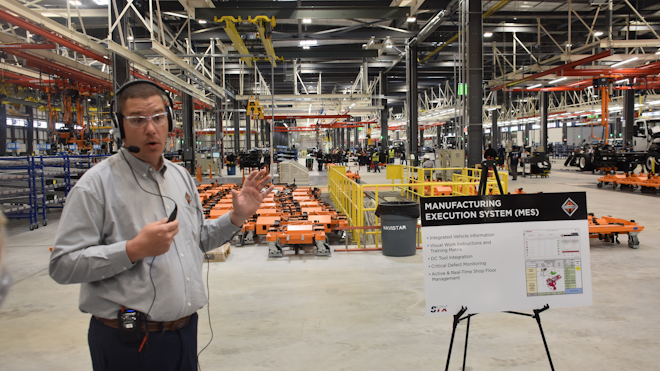 During a March 23 plant tour, Stephen Mudd, area director for general assembly, points out the facility's manufacturing execution system (MES), which can log all equipment defects electronically and pull various reports and information from some 60,000 different parts that go into every truck.