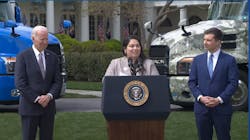 Flanked by President Joe Biden and Transportation Secretary Pete Buttigieg, Maria Rodriguez, who recently became a truck driver apprentice for NFI, discusses her newfound career in trucking during an April 4 event at the White House.