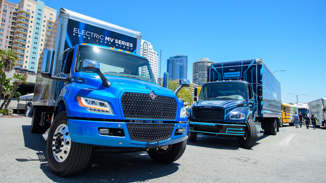 International’s eMV, left, and Freightliner’s eM2, battery-electric medium-duty trucks on display at ACT Expo 2022 in Long Beach, California.