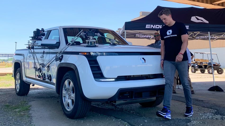 Cincinnati Bengals quarterback Joe Burrow walks to the passenger seat of the Lordstown Endurance EV pickup truck before some marketing shoots on June 21.