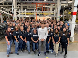 Joe Burrow poses for a photo with Lordstown Motors Corp. and Foxconn employees inside the plant in northeast Ohio.