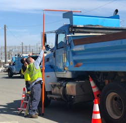PG&amp;E workers review vehicle heights during a safety summit at the fleet&apos;s Antioch facility.