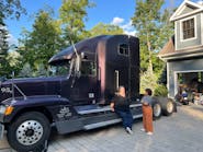 Owner-operator Jess Graham leans against her 1995 Freightliner FLD, nicknamed &apos;The Black Widow.&apos;