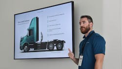 Sam Ellis, a product manager at Volvo Trucks North America, review&apos;s the company&apos;s Gold Contract for VNR Electric customers at the Volvo Customer Center on Sept. 29.