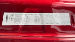 A vehicle certification label includes load and inflation ratings and tire sizes for a Kenworth model.