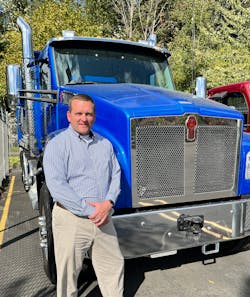 Kenworth Section Manager for Battery Electric Vehicle Development and member of the U.S. Navy Reserve Mark Buckner with a Kenworth T880.