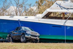 A truck pinned by a boat after Hurricane Ian struck Fort Myers, Florida. A truck pinned by a boat after Hurricane Ian struck Fort Myers, Florida.