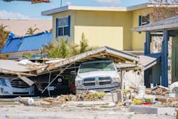 A truck is pinned under storm debris from Hurricane Ian in Fort Myers, Florida. A truck is pinned under storm debris from Hurricane Ian in Fort Myers, Florida.