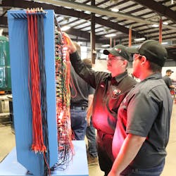 An instructor at NVI-Blairsville teaches a student how to diagnose wire harness issues. An instructor at NVI-Blairsville teaches a student how to diagnose wire harness issues.