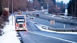 A truck stopped on the shoulder of a highway exit ramp. A truck stopped on the shoulder of a highway exit ramp.