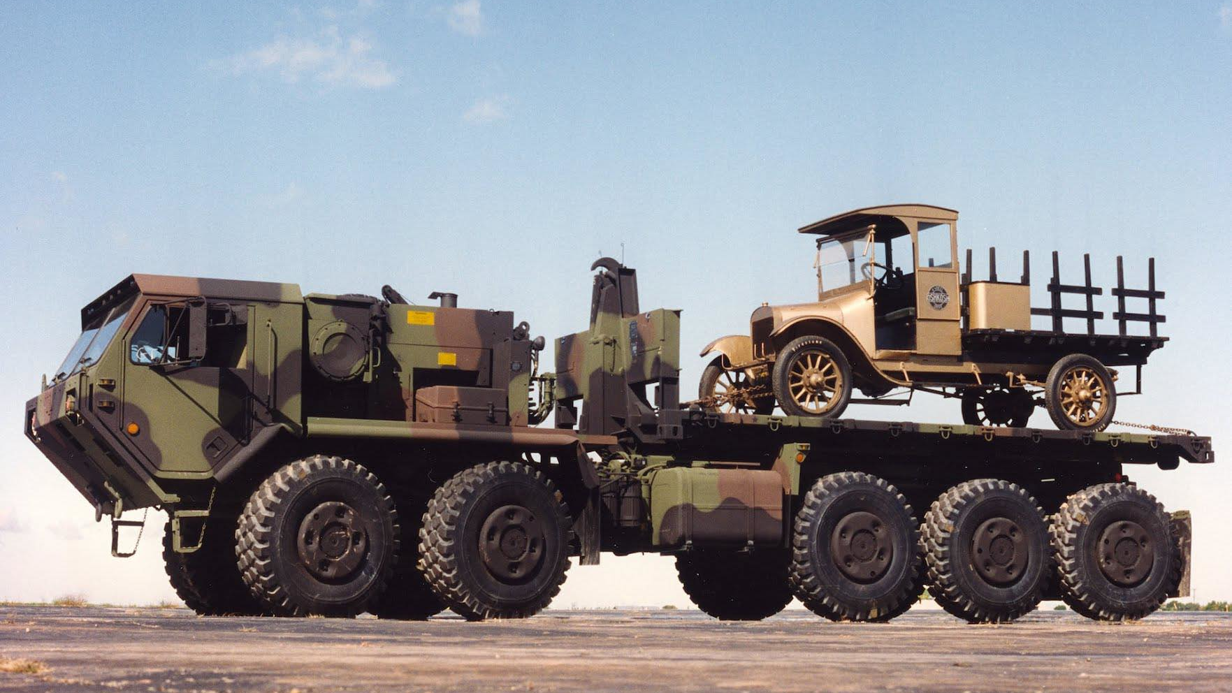 Old Betsy, a 1917 design from the company that would become Oshkosh, hitches a ride on a more modern Oshkosh Defense 10X10.