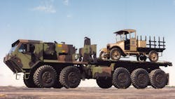 Old Betsy, a 1917 design from the company that would become Oshkosh, hitches a ride on a more modern Oshkosh Defense 10X10. Old Betsy, a 1917 design from the company that would become Oshkosh, hitches a ride on a more modern Oshkosh Defense 10X10.
