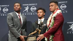 Ohio State Buckeyes quarterback Dwayne Haskins, left, Oklahoma Sooners quarterback Kyler Murray and Alabama Crimson Tide quarterback Tua Tagovailoa pose with the Heisman Trophy at the Marriott Marquis in New York City in 2018.