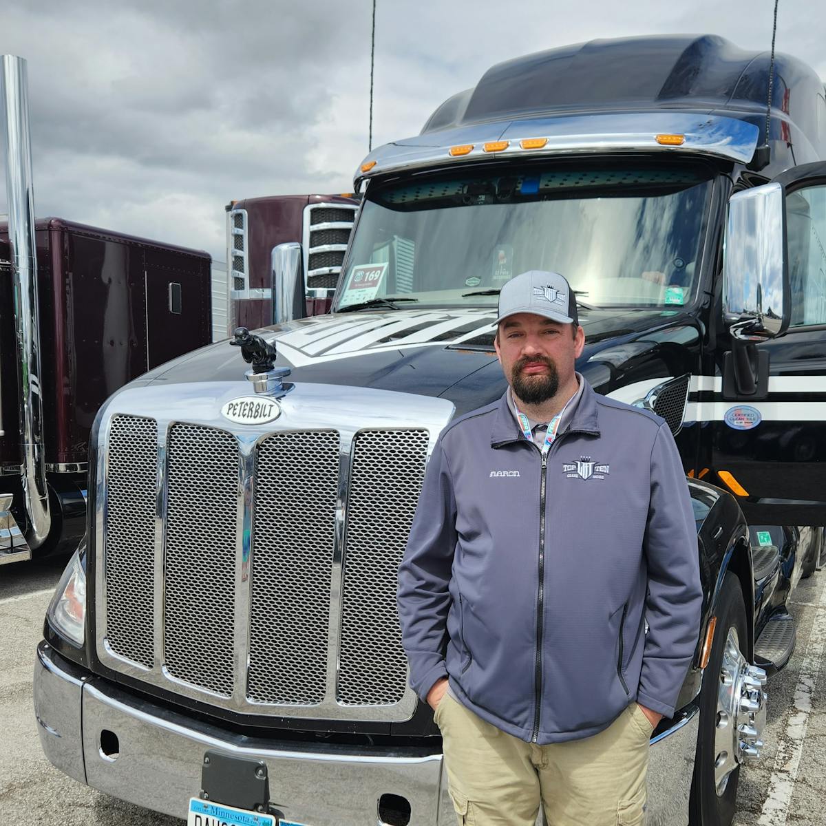 Aaron Puterbaugh, a driver for carrier Long Haul Trucking out of Minnesota, next to his 2021 Peterbilt 579 Ultraloft.
