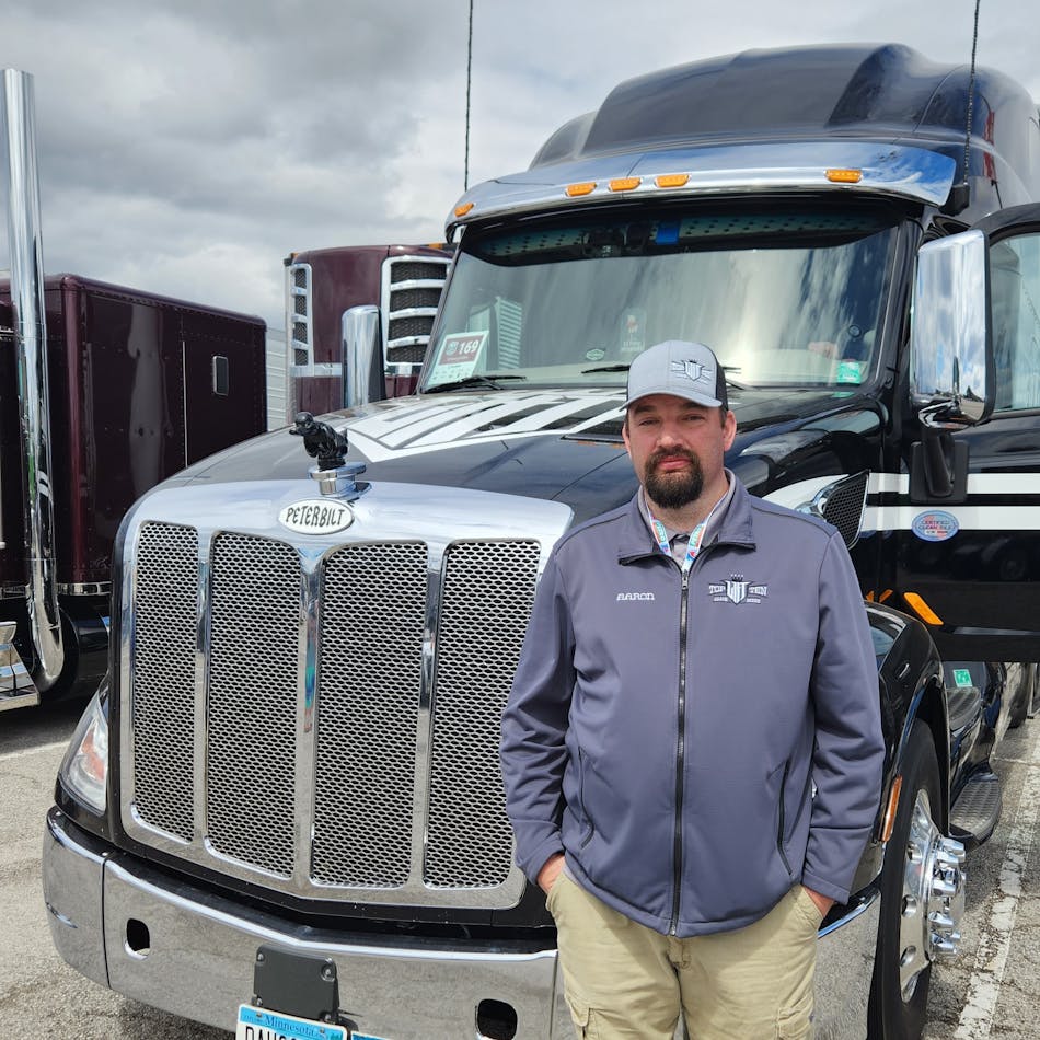 Aaron Puterbaugh, a driver for carrier Long Haul Trucking out of Minnesota, next to his 2021 Peterbilt 579 Ultraloft.