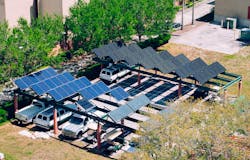 Work trucks charge in solar-powered charging infrastructure in Florida. Work trucks charge in solar-powered charging infrastructure in Florida.