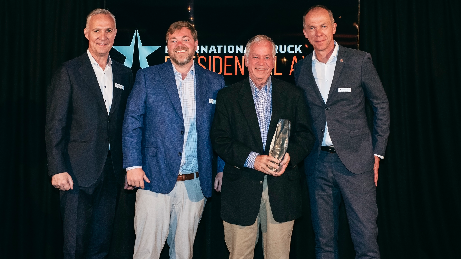 From left, G&ouml;ran Nyberg, Navistar&rsquo;s EVP of Commercial Operations; Vaughan Waters, Waters Group; David Waters, Dealer Principal, Waters Group; and Mathias Carlbaum, Navistar president and CEO. Vaughan and David Waters accept the 2022 International Dealer of the Year award for Waters Group at the annual President's Club meeting in Stockholm, Sweden.