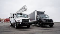 The new eM2 on-highway truck (right) is available in Class 6 and Class 7 configurations. Freightliner also is expanding the eM2 medium-duty truck for vocational applications (left), with utility applications among the first vocational offerings.
