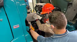 Technicians perform maintenance and repairs on customers’ Volvo VNR Electric trucks at one of the OEM’s certified EV dealerships.