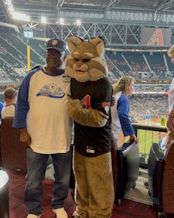 One of Swift's drivers poses with the Arizona Diamondbacks' mascot, Baxter the Bobcat. One of Swift's drivers poses with the Arizona Diamondbacks' mascot, Baxter the Bobcat.