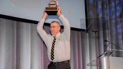 Gragg hoists up his grand champion award at NTDC in Columbus, Ohio.