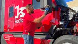 A Kodiak Robotics engineer checks a sensor on an autonomous truck in Texas.