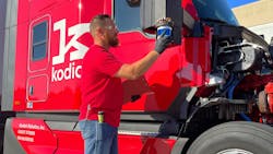 A Kodiak Robotics engineer checks a sensor on an autonomous truck in Texas. A Kodiak Robotics engineer checks a sensor on an autonomous truck in Texas.