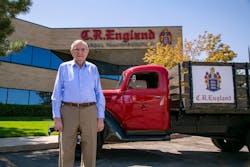 G.E. &ldquo;Gene&rdquo; England, who still comes to work twice a week, stands with a vintage C.R. England truck outside the fleet&apos;s Salt Lake City headquarters.