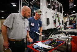 Technicians review repair orders during the Rush Technicians Skills Rodeo in 2022.