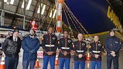 Goodyear Airships associates and U.S. Marine Corps Reserve members pose in front of the Goodyear Blimp at past Toys for Tots donation drives.