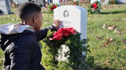 Boy touches headstone