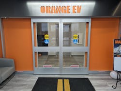 Orange EV's lobby features a replication of its tractor's bumper plate. Orange EV's lobby features a replication of its tractor's bumper plate.