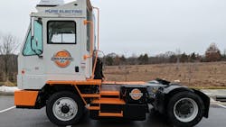 Orange EV e-Triever terminal tractor. Orange EV e-Triever terminal tractor.