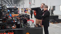 Orange EV co-founder Kurt Neutgens shows Kansas Gov. Laura Kelly an Orange EV chassis on the production line. Orange EV co-founder Kurt Neutgens shows Kansas Gov. Laura Kelly an Orange EV chassis on the production line.