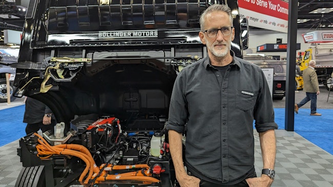 Robert Bollinger, CEO and founder of Bollinger Motors, stands with his B4 chassis cab model, a battery-electric Class 4 work truck. at NTEA's Work Truck Week in Indianapolis.
