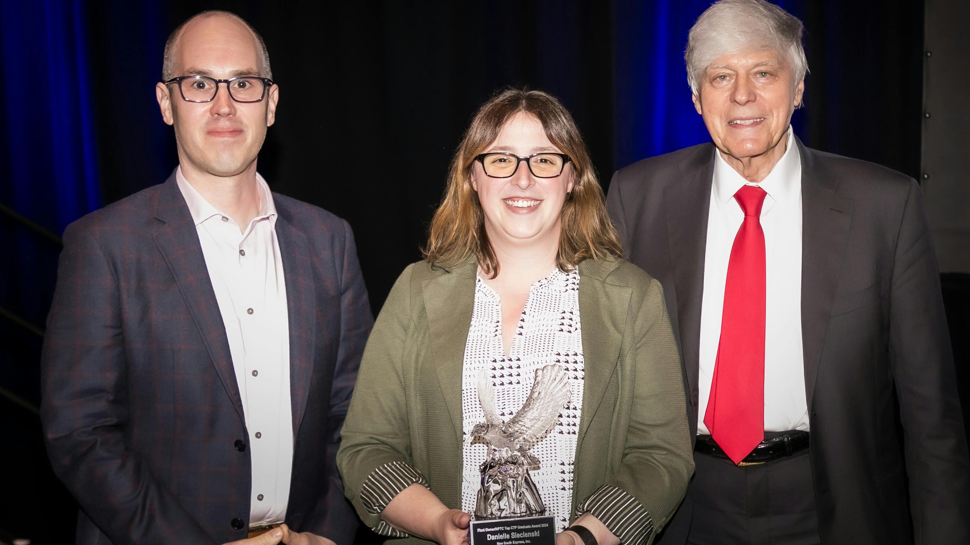 FleetOwner Editor-in-Chief Josh Fisher, left, New South Express fleet safety manager Danielle Siecienski, and Gary Petty, CEO of National Private Truck Council. Siecienski was the 2024 top graduate of NPTC's Certified Transporation Professional program.