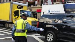 A New York police officer directs traffic in lower Manhattan.