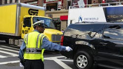 A New York police officer directs traffic in lower Manhattan. A New York police officer directs traffic in lower Manhattan.