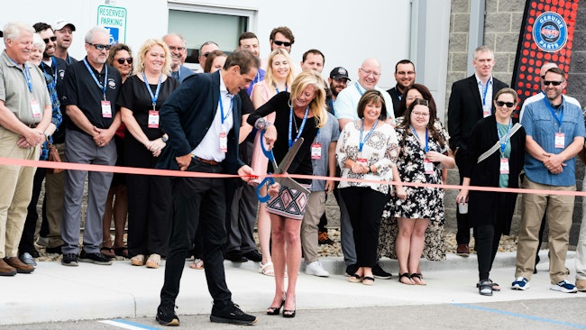 Steve Bennett of Utility Trailer Manufacturing and Leann Wannemacher cut the ribbon on the new Toledo, Ohio, facility.