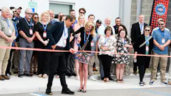 Steve Bennett of Utility Trailer Manufacturing and Leann Wannemacher cut the ribbon on the new Toledo, Ohio, facility.