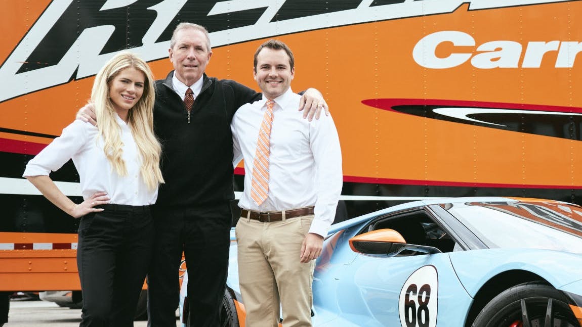 Tom Abrams, Reliable Carriers' owner, center, with his daughter Lauren and son Brian.
