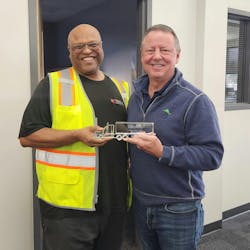 ASL President Scott Willert presents independent driver partner Wayne Coffey with an award for two million miles.
