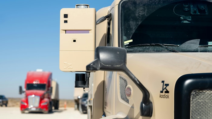 Two Kodiak RoboTrucks are parked in the Permian Basin, where Atlas Energy Solutions provides proppant fracking material for oil and natural gas extraction.