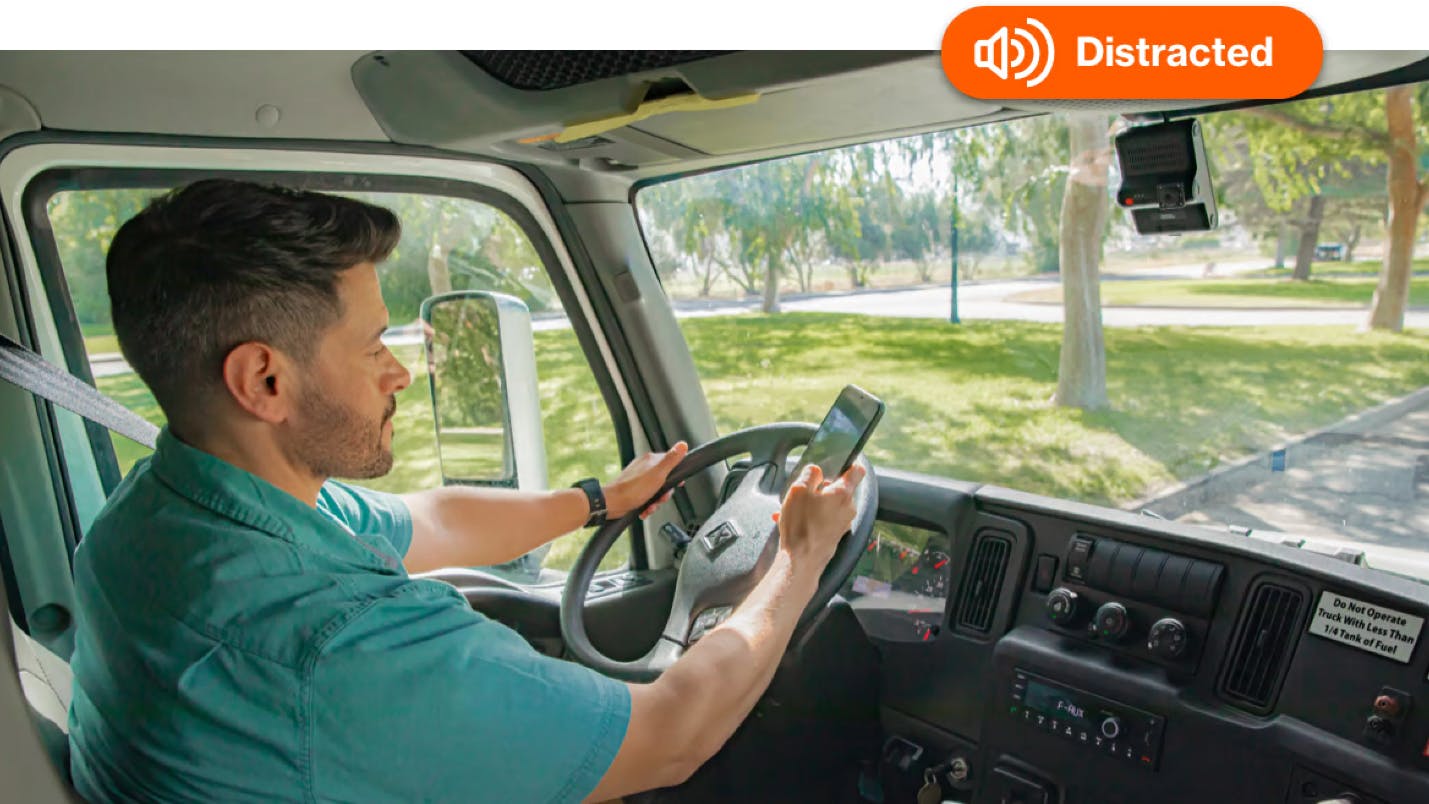 man driving distracted with distraction alert