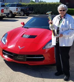 Riels stands with her Corvette and her car show award in 2018 Riels stands with her Corvette and her car show award in 2018