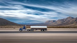 A heavy-duty tractor hauls a tank truck along a highway. A heavy-duty tractor hauls a tank truck along a highway.