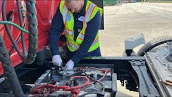 A technician installs the IdleLess hardware on a truck. A technician installs the IdleLess hardware on a truck.