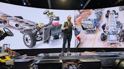 Harbinger CEO John Harris stands on his medium-duty truck hybrid chassis during ACT Expo in Anaheim, California. He said the vehicle could get up to 500 miles between charges. Harbinger CEO John Harris stands on his medium-duty truck hybrid chassis during ACT Expo in Anaheim, California. He said the vehicle could get up to 500 miles between charges.