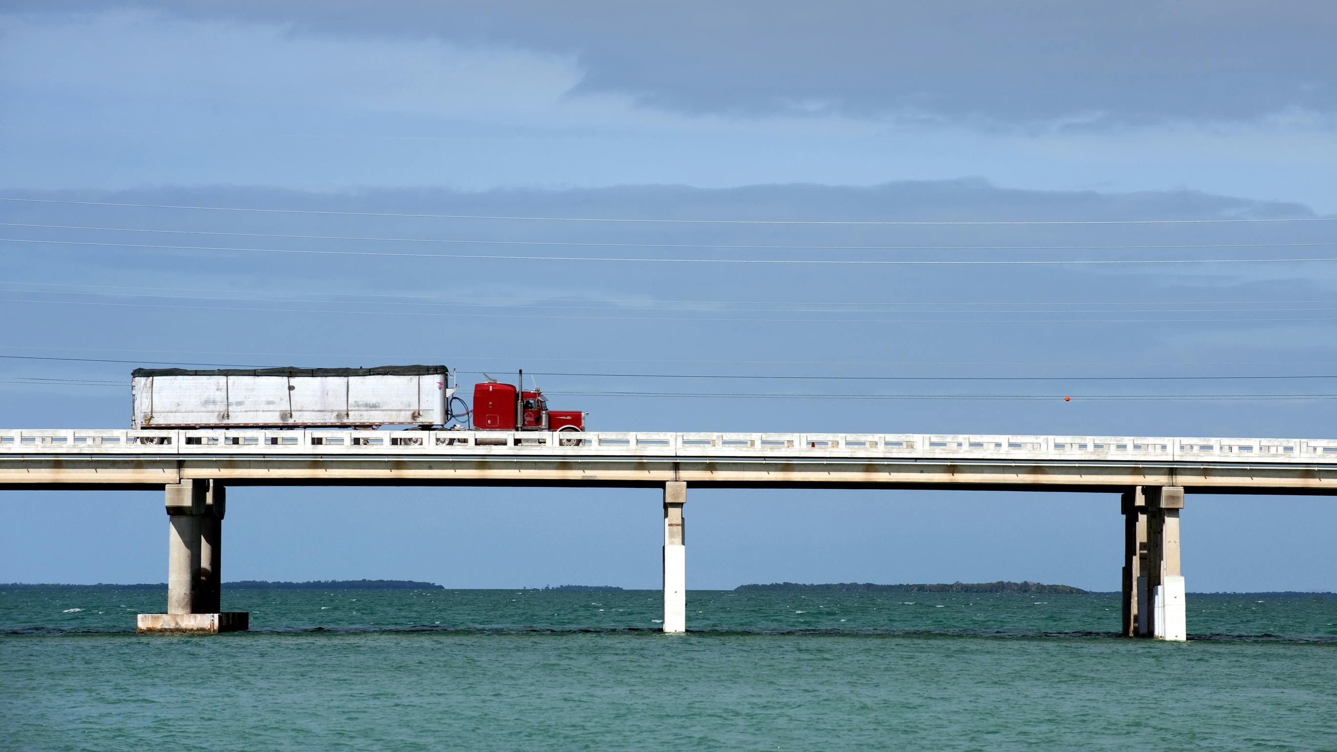 Semi truck on bridge over water in the Florida Keys