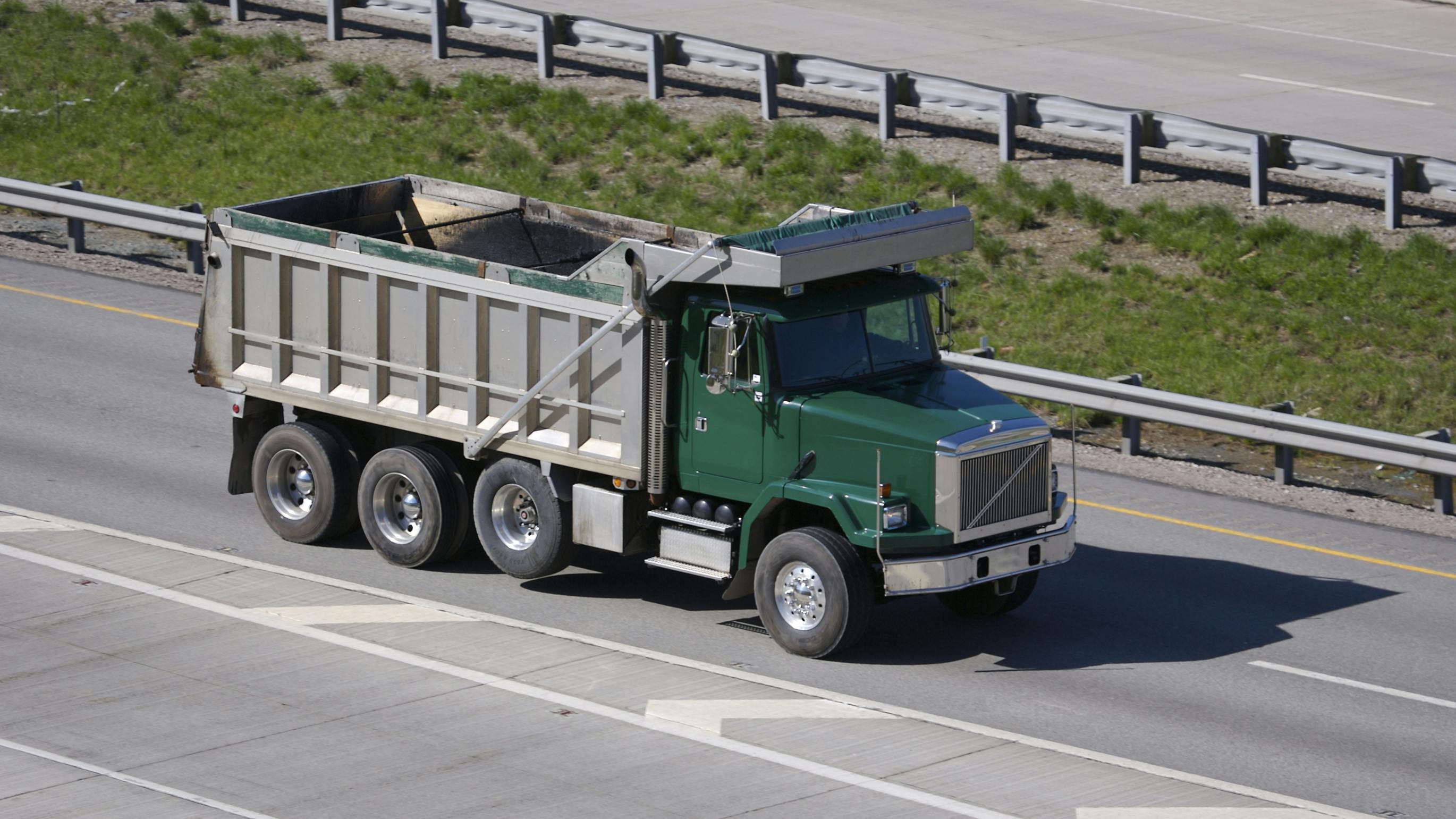 green dump truck on highway